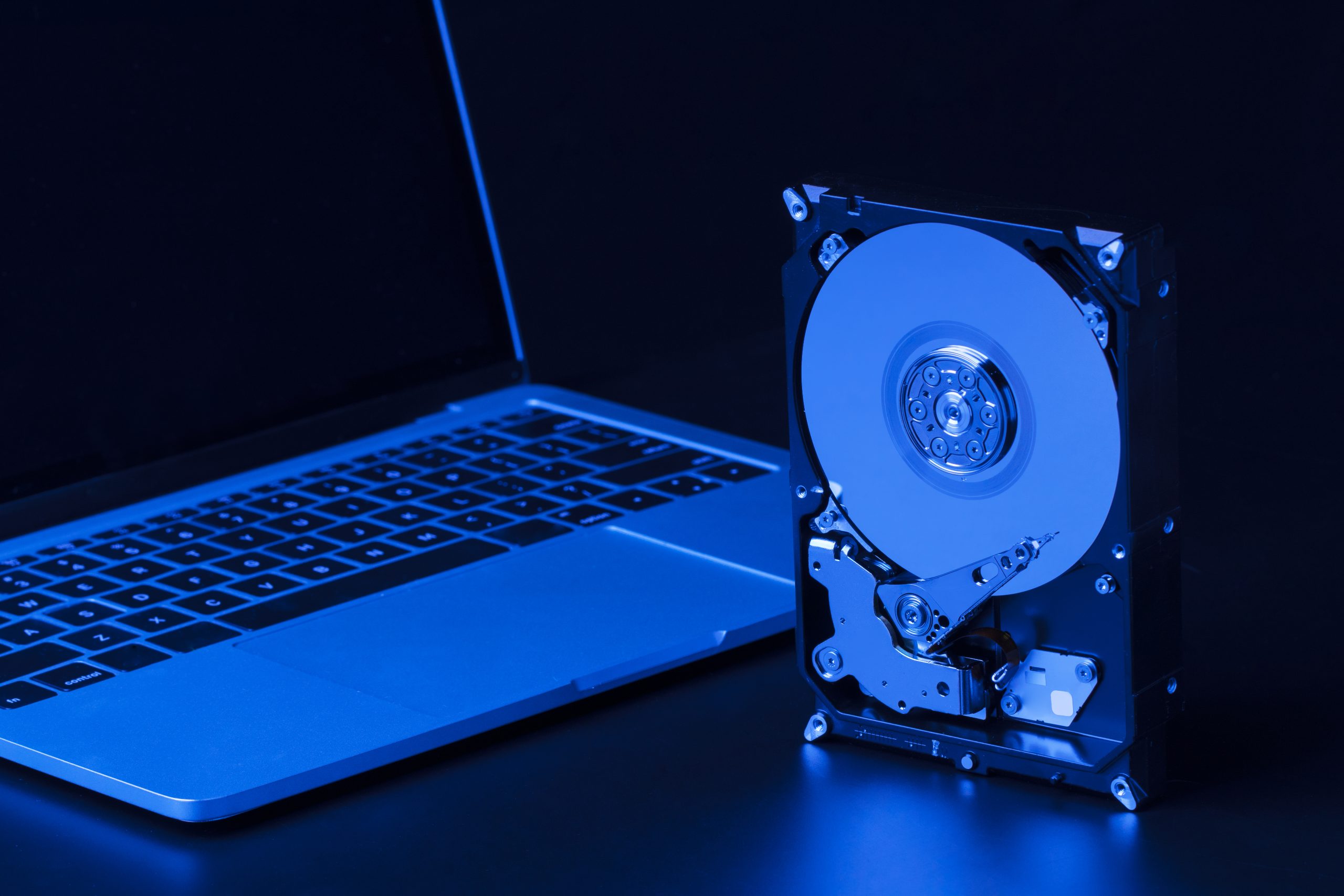 hard drive with blue light laptop high angle scaled